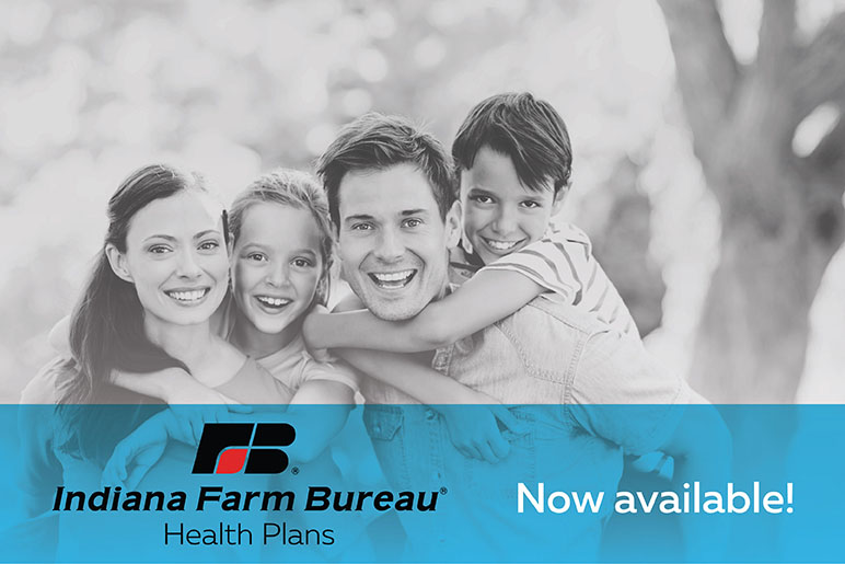 Family of four with their children on their backs smiling with a logo of Indiana Farm Bureau in front of them