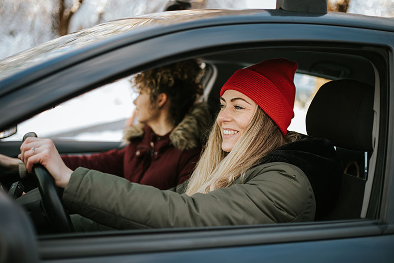 Woman driving with another woman in the winter 